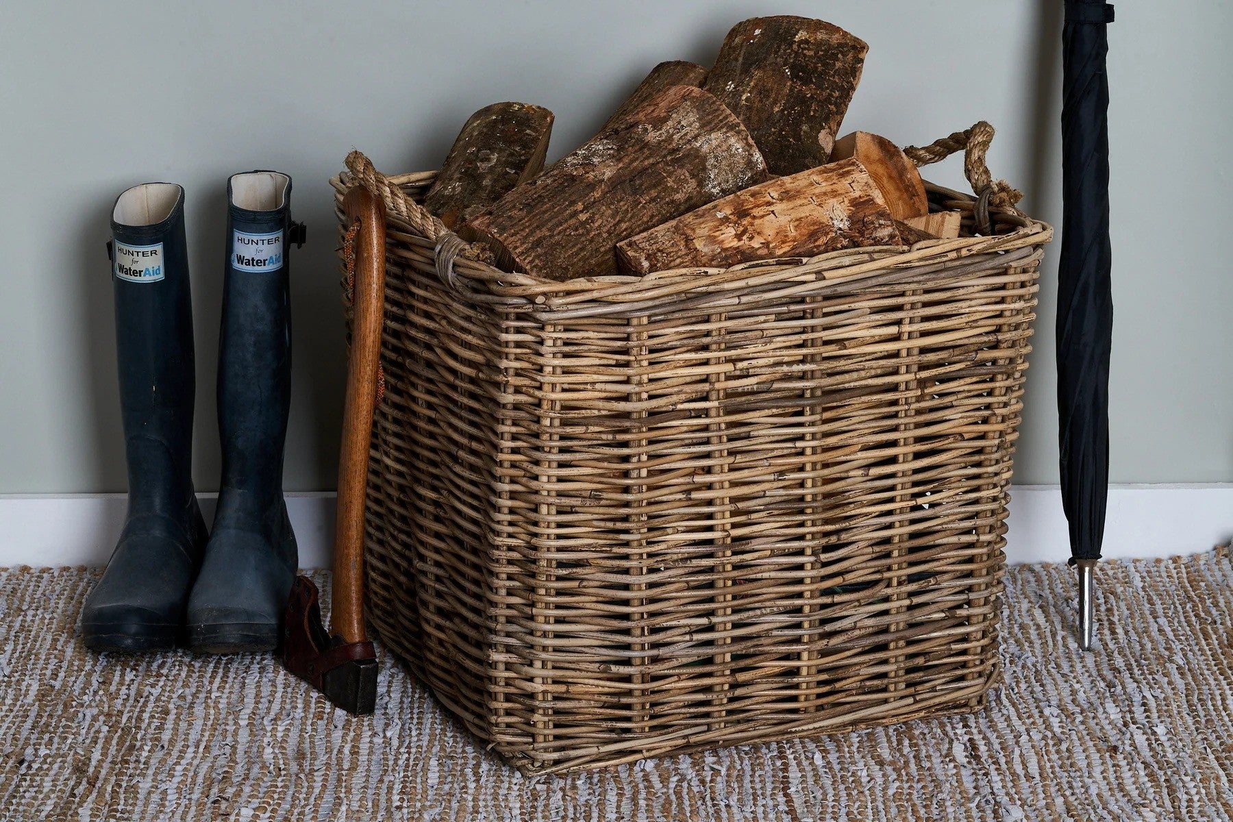 wellies and a rattan log basket