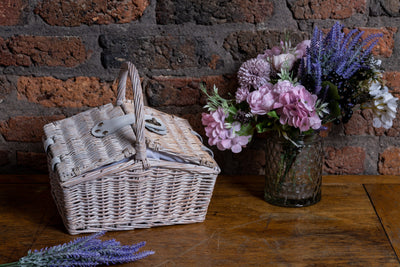 Small White Double Lidded Hamper next to a bouquet of flowers
